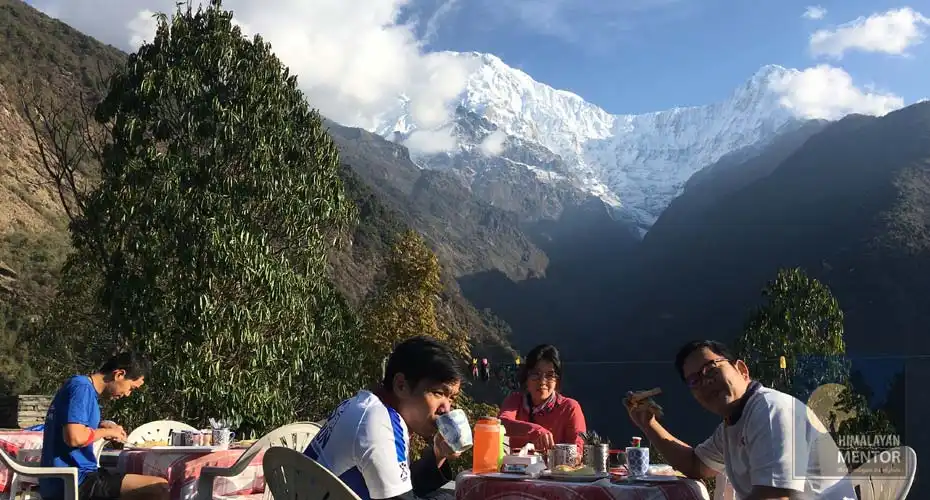 Trekkers are enjoying their breakfast from the lodge at Chhomrong 