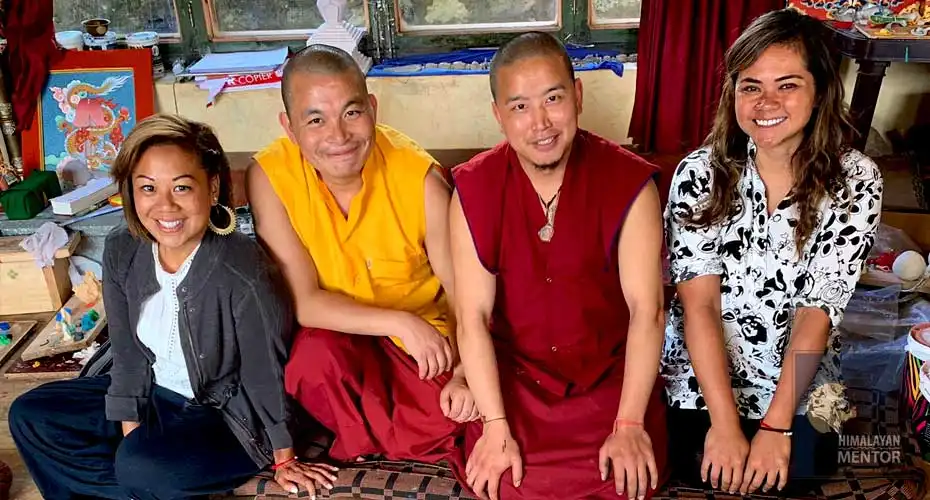 Happy clients with resident monks at a monastery in Bhutan