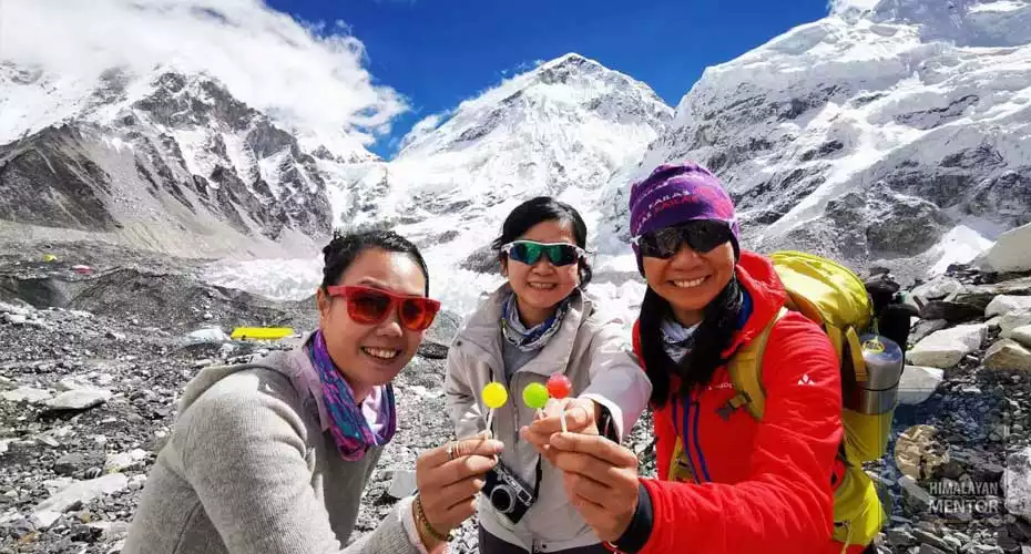 HM's clients are posing for a photograph at Everest base camp