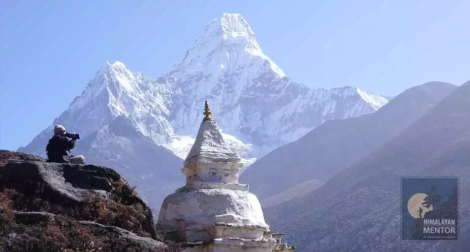 Our client is taking a sip of water while enjoy the beautiful Ama Dablam