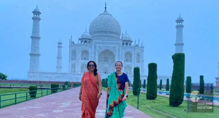 Our clients are posing for a photograph in-front of Taj Mahal