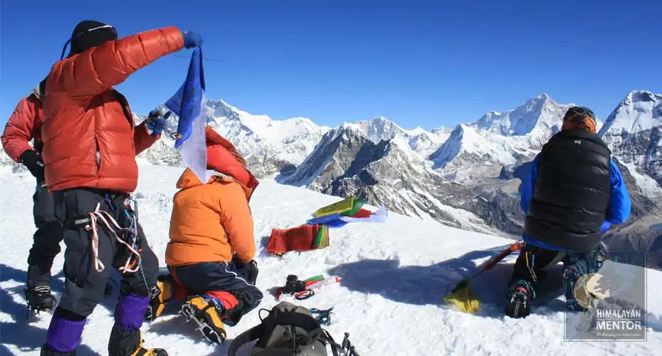 At the summit of Mera peak, climbers are with Buddhist prayer flag