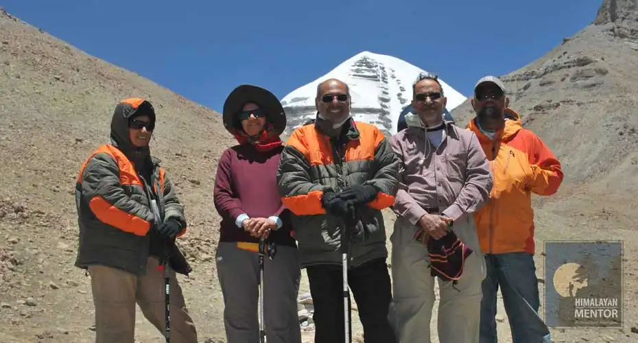 Pilgrimage tourists posing for photograph and in the background Mt. Kailash