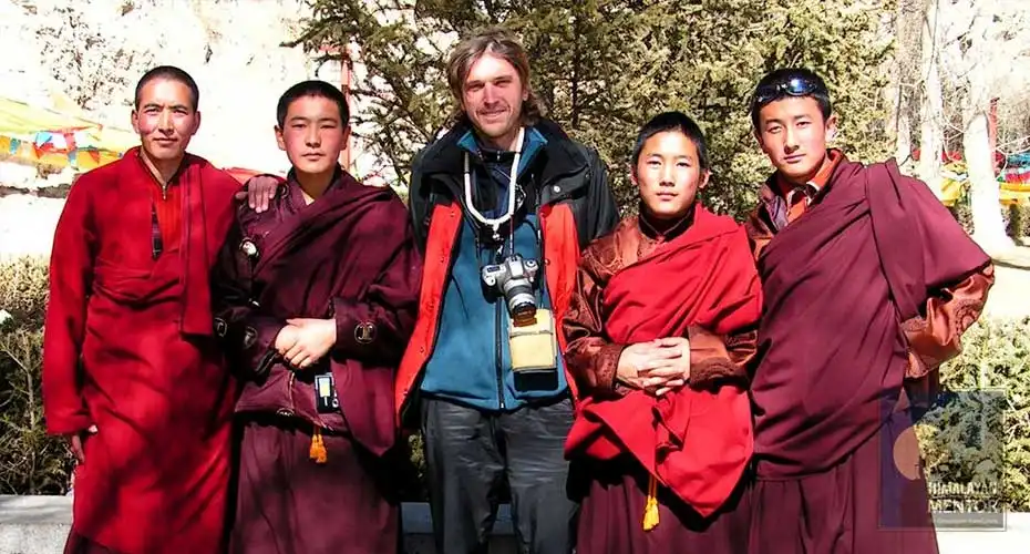 Happy client taking a photo with Tibetan Buddhist monks